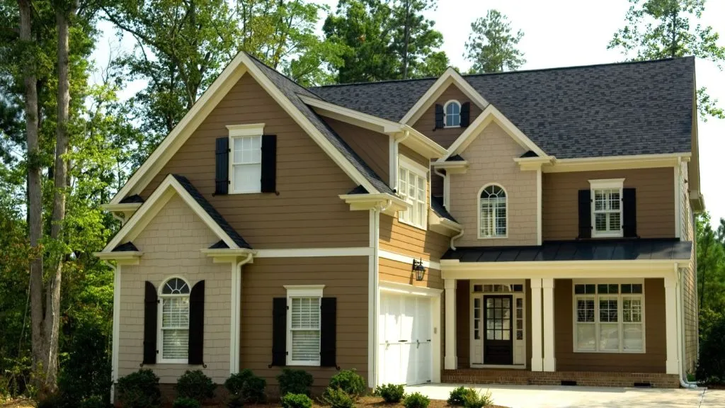 Two Story Tan House With Shutters
